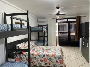 a room with three bunk beds and a bed in it at Ipanema Club Hostel in Rio de Janeiro