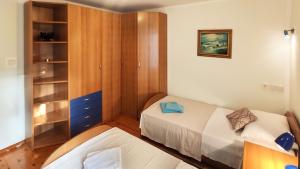 a small bedroom with a bed and a cabinet at Lilly in Rijeka