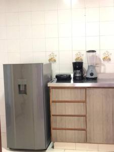 a kitchen with a stainless steel refrigerator and a blender at Sweet Home RIOHACHA in Ríohacha