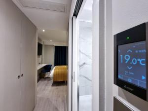 a room with a door with a tv and a bedroom at NOX Edgware Road in London