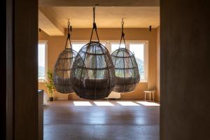 a room with three hanging baskets hanging from the ceiling at Hotel Del Lago Piediluco Active & SPA in Piediluco