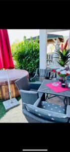a patio with a table and chairs and an umbrella at La Suite in Baden-Baden