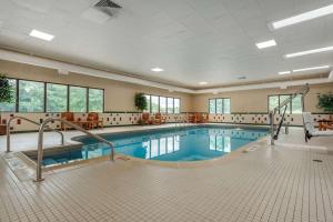 a large swimming pool in a building with a pool at Comfort Suites near Route 66 in Springfield