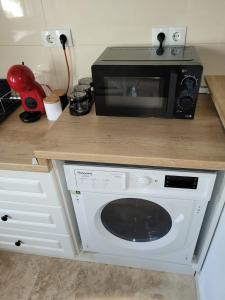 a microwave sitting on top of a kitchen counter at Lovely Apartment Near City Center & Free Parking in Cluj-Napoca +7 photos