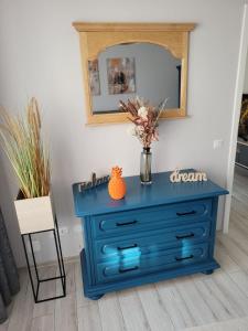 a blue dresser in a room with a mirror at Lovely Apartment Near City Center (w/ Parking) in Cluj-Napoca