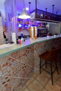 a bar with a counter and a chair in a room at LOFT Apart&Hostal in Lloret de Mar