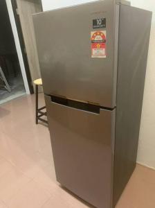 a stainless steel refrigerator with a sign on it at Queen Room Semi Attached Bathroom Bukit Mertajam Alma Impian in Bukit Mertajam