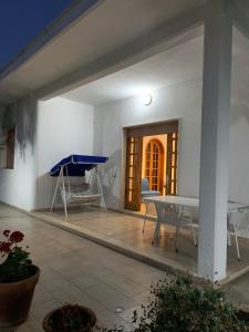 a living room with a table and a blue bench at La Villetta al Mare in Porto Cesareo