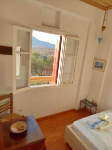 a bedroom with a bed and a large window at ArtHome0A in Panormos