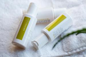 two tubes of sunscreen sitting on top of a towel at B&B Langeveldemolen in Merchtem +20 photos