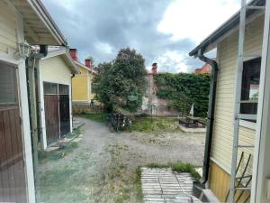 an empty yard between two houses with a fence at Sadan vuoden talo in Pori