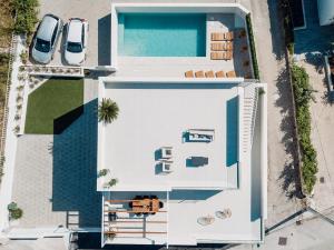 an overhead view of a white building with a swimming pool at High View House in Okrug Donji