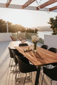 a wooden table and chairs on a patio at High View House in Okrug Donji