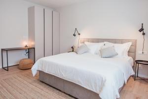 a bedroom with a large bed with white sheets and pillows at High View House in Okrug Donji +37 photos