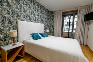 Postel nebo postele na pokoji v ubytování Sanxenxo Apartamentos 2 habitaciones con piscina, garaje a 150 mt playa Silgar + 34 fotografií