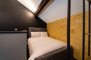 a small bedroom with a bed in a room at The Luxury Penthouse by Sasco Apartments in Blackpool