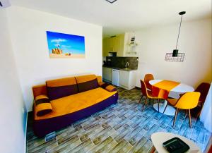 a living room with a couch and a table at Lilac Apartman in Balatonlelle