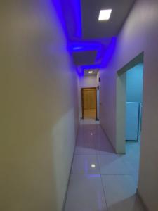a hallway with a purple ceiling in an office building at شقق ليالي الشرق للوحدات 3 in Al Ahsa