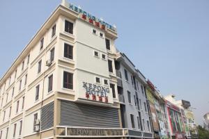 a white building with a sign on it at Kepong Hotel in Kuala Lumpur