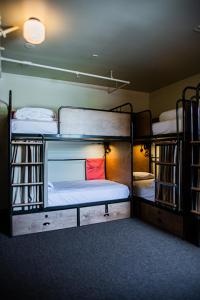 a room with three bunk beds in it at KEX Hotel in Portland