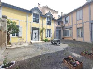 a group of buildings with chairs in a courtyard at Obalie-Le Vignemale in Cauterets