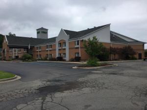 an empty parking lot in front of a building at Wingate by Wyndham Brighton in Brighton