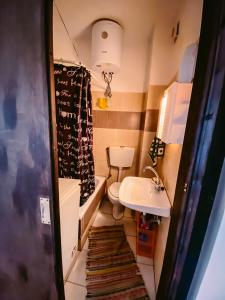 a small bathroom with a sink and a toilet at HILL SANDALI HOUSE in Sitia
