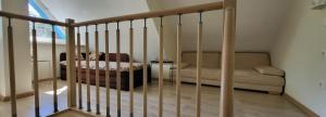 a living room with a couch and a stair railing at Pergolt Apartment in Pervalka