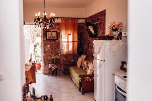 a kitchen with a couch and a refrigerator in it at HILL SANDALI HOUSE in Sitia