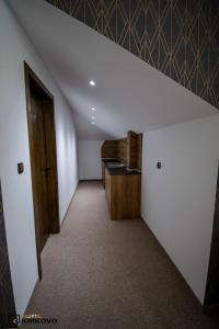 an attic room with a hallway with a door at Hotel Kirkovo in Kirkovo