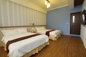Uma cama ou camas num quarto em 輕旅小站 Soft Travel Hostel
