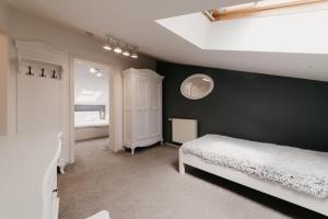 1 dormitorio con cama y pared negra en Meteor Central en Cluj-Napoca