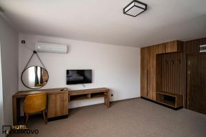 a room with a mirror and a desk and a tv at Hotel Kirkovo in Kirkovo