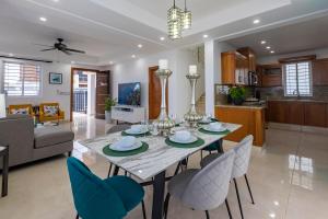a dining room and living room with a table and chairs at Vista Bella 46 in San Felipe de Puerto Plata
