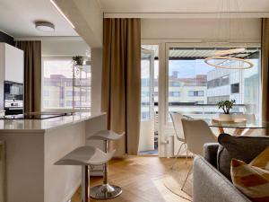 a kitchen and living room with a table and chairs at Borg Housing City Central in Pori