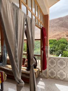 a room with a window with a view of the grand canyon at Dar Relax Hostel, Gorges de Todra in Tinerhir