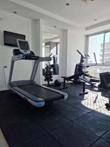 a gym with several treadmills and cardio machines at Villaggio Hotel Boutique in Mendoza