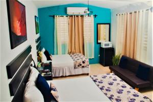 a living room with a bed and a couch at Eventuality B&B New Kingston in Kingston