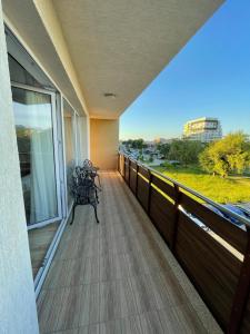 a balcony with a bench and a window at Coresi Long Stay Apartment in Braşov