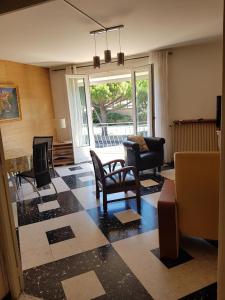a living room with chairs and a table and a fireplace at City Break in Narbonne