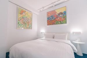 a bedroom with a painting on the wall at Mei Stay in Taipei