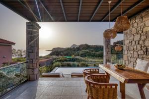 een eetkamer met uitzicht op de oceaan bij Lemnosthea Luxury Residences in Agios Ioannis Kaspaka