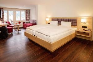 Säng eller sängar i ett rum på Hotel Caprice - Grindelwald