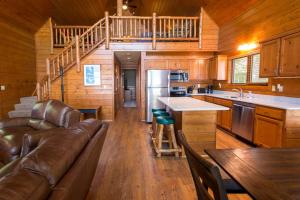 a living room with a couch and a kitchen in a cabin at Gull Haven 704 in Nisswa