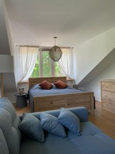 a bedroom with a bed and a large window at Zarzecze 27A in Augustów