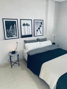 a bedroom with two beds and pictures on the wall at Fresh apartment, 2 bedroom, 2 bathroom, 2 lovely poolareas in Los Alcázares