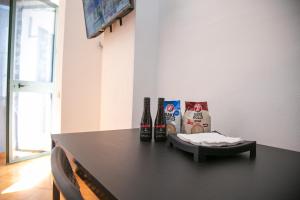 two bottles of beer sitting on a black table at A&B Apartment in Golem