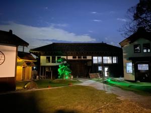 a house with a green christmas tree in the yard at One Night, One View, Lifelong Marriage, Yotsukaido - Vacation STAY 12735 in Yotsukaidō