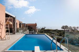 a swimming pool on the roof of a house at Lemnosthea Luxury Residences in Agios Ioannis Kaspaka
