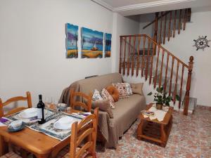 a living room with a couch and a table at Casa Valentino in Santa Pola